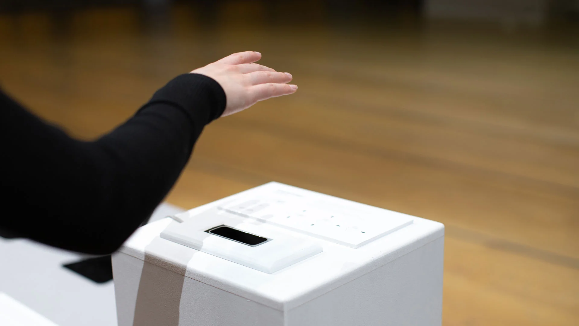 Visitor interacting with installation podium